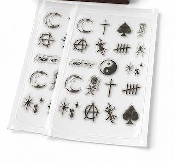BlemInk tattoo-inspired pimple patches shown with their dark brown retail box and two clear plastic sheets containing black temporary tattoo-style designs on a white background.